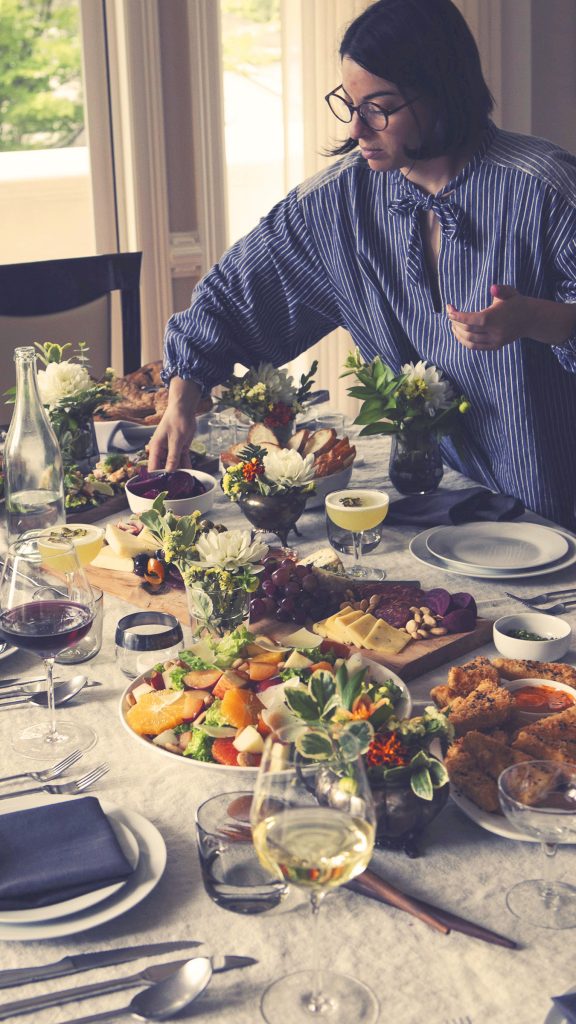 Photograph of Woman Placing Food on Table