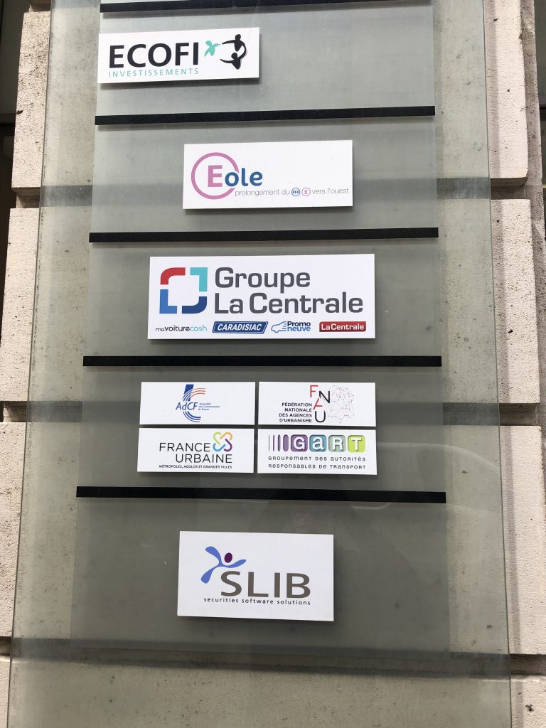 Professional cards of companies and logos on a building in Paris